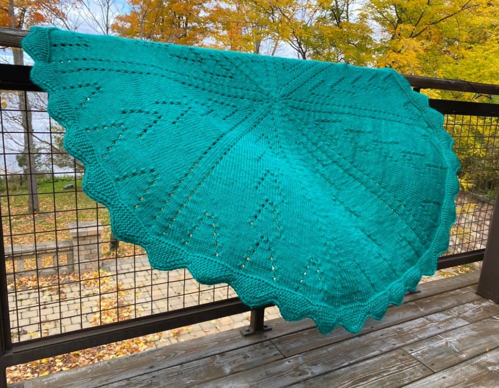 Circular Baby blanket on a railing in the wind
