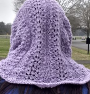 Back of head view of purple lacey knit cowl.